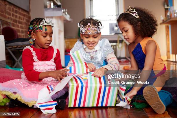 girls with tiaras opening gifts at party - birthday tiara stock pictures, royalty-free photos & images