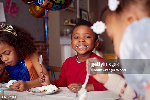 children eating cake at party - boys birthday stock pictures, royalty-free photos & images