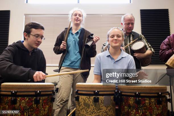 students playing bongo drums in high school band class - instrument à percussion photos et images de collection