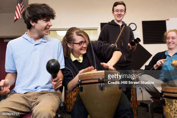 students playing bongo drums in high school band class - maracas fotografías e imágenes de stock