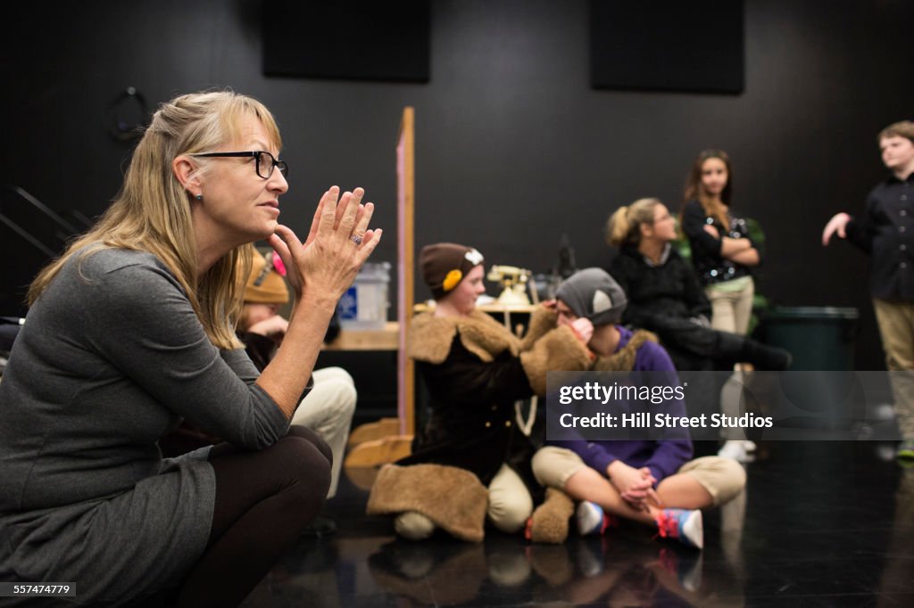 Teacher talking to middle school drama class