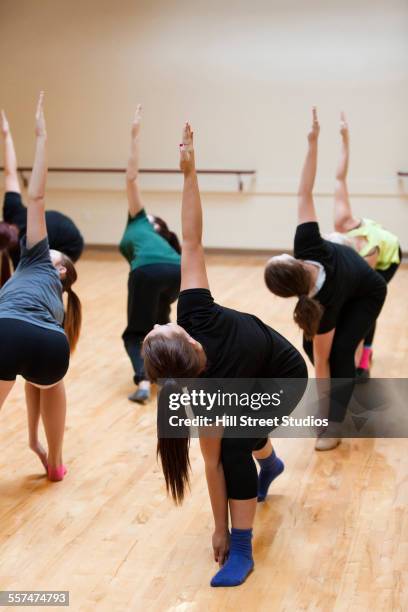dancers with arms outstretched rehearsing in gym - dance routine stock pictures, royalty-free photos & images