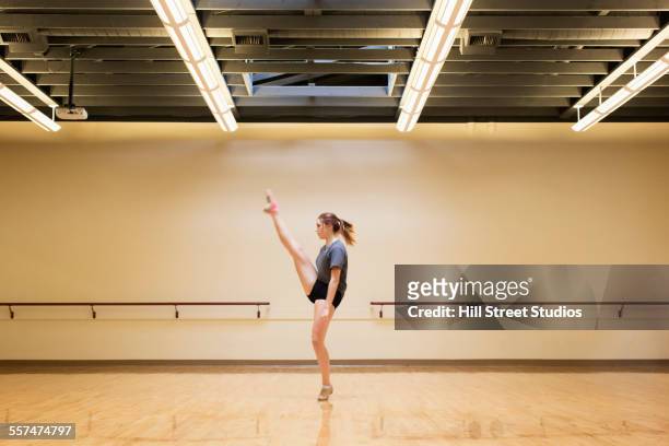 Caucasian dancer rehearsing in studio