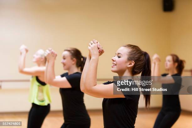 dancers with hands clasped rehearsing in studio - teen cheerleader 個照片及�圖片檔
