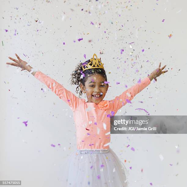 mixed race girl wearing tiara throwing confetti - black dress party bildbanksfoton och bilder