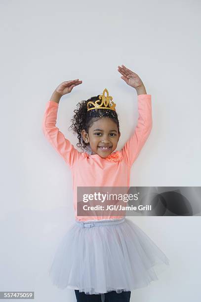 smiling mixed race ballerina posing in tiara - child princess stock pictures, royalty-free photos & images