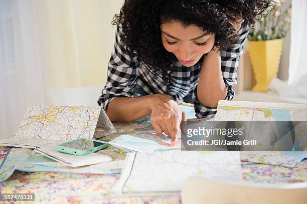 mixed race woman planning road trip with maps - mid atlantic usa stock pictures, royalty-free photos & images