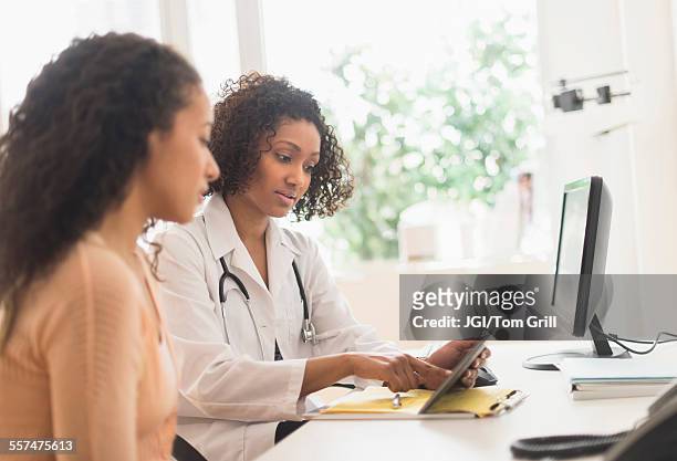 doctor and patient using digital tablet in office - doctor and patient talking imagens e fotografias de stock