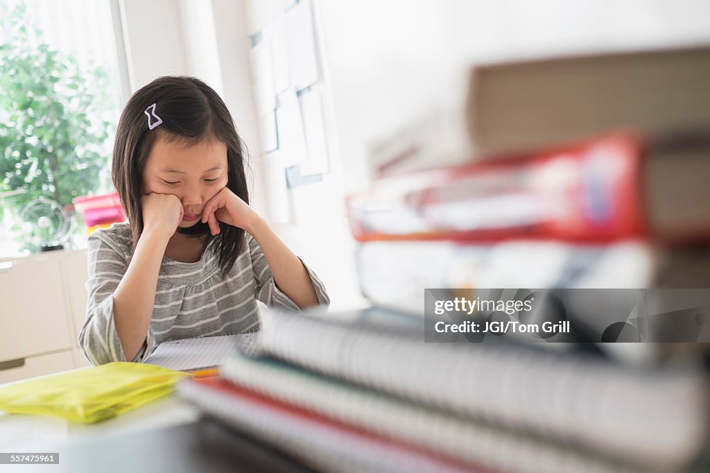 Chinese student thinking about homework