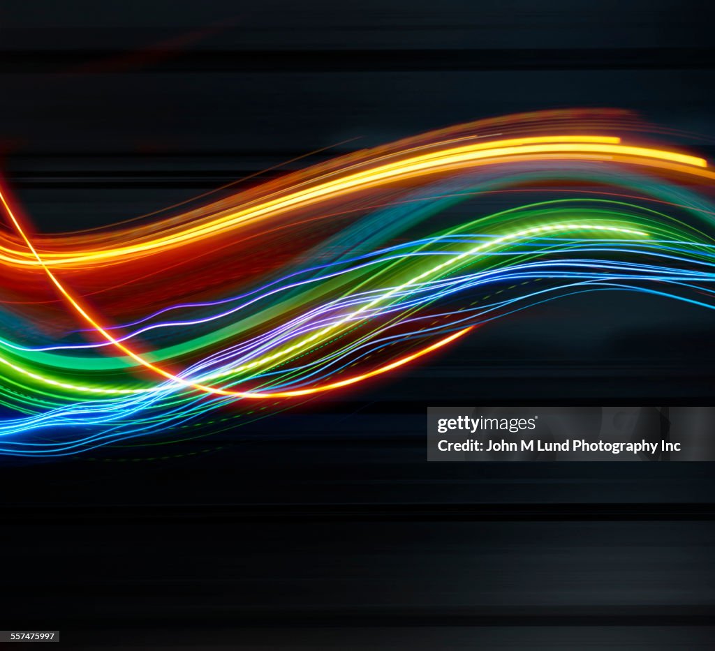 Blurred light trails against blurred black background