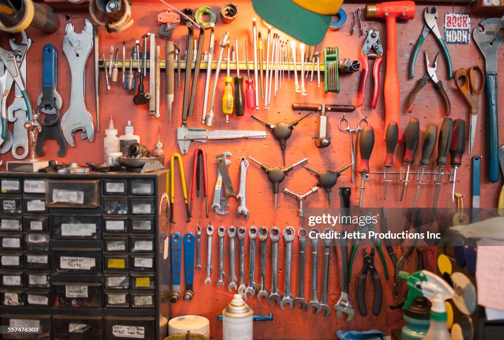 Tools hanging from bicycle repair shop wall