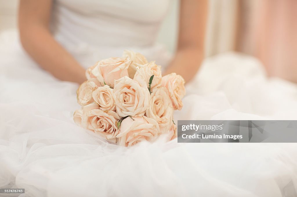 Close up of bride holding bouquet of flowers