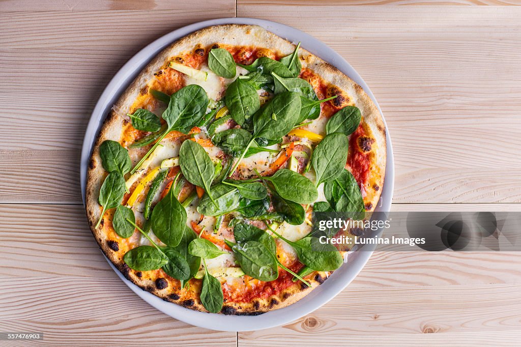 Close up of pizza with fresh spinach