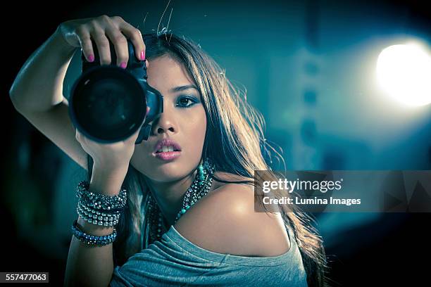 glamorous woman photographer holding camera - fashion photographer stock pictures, royalty-free photos & images