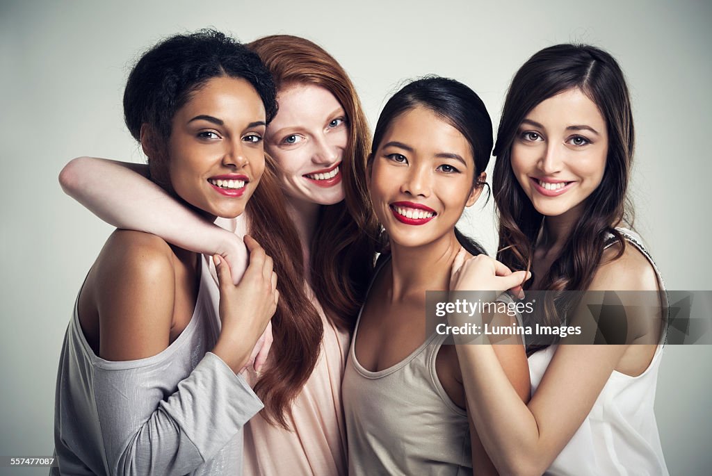 Close up of smiling women hugging