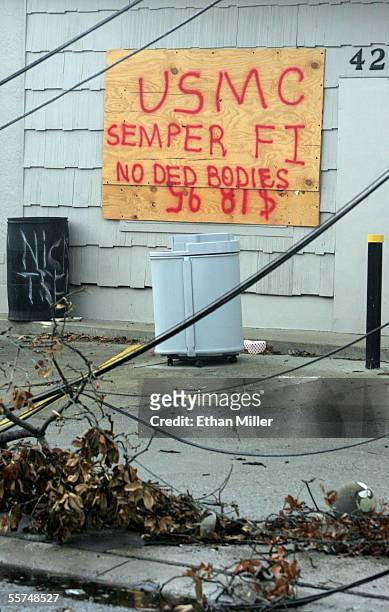 Sign on the side of Mike's Hardware indicates United States Marine Corps searchers found no bodies as a result of Hurricane Katrina September 23,...