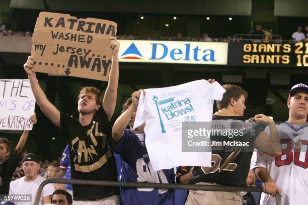 The New Orleans Saints fans hold up signs about hurrican Katrina during the game with the New York Giants on September 19, 2005 at Giants Stadium in...
