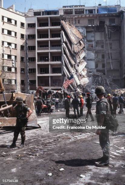 American Marines stand a stunned guard as rescuers examine the wreckage after the suicide truck bombing of the American embassy that killed 63 people...