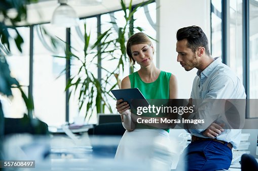 Business people using digital tablet in office Business people using digital tablet in office