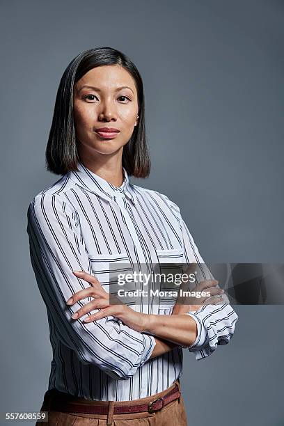 portrait of confident businesswoman - striped shirt stockfoto's en -beelden