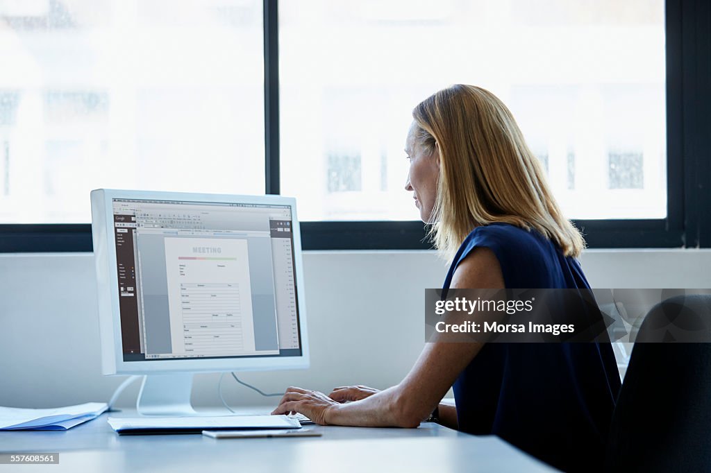 Businesswoman using computer at desk