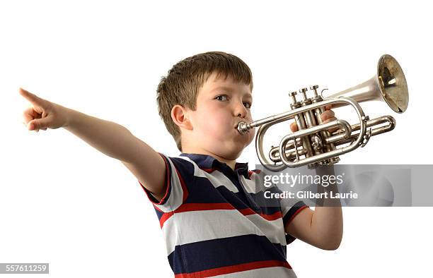 boy playing a trumpet - trumpet stockfoto's en -beelden