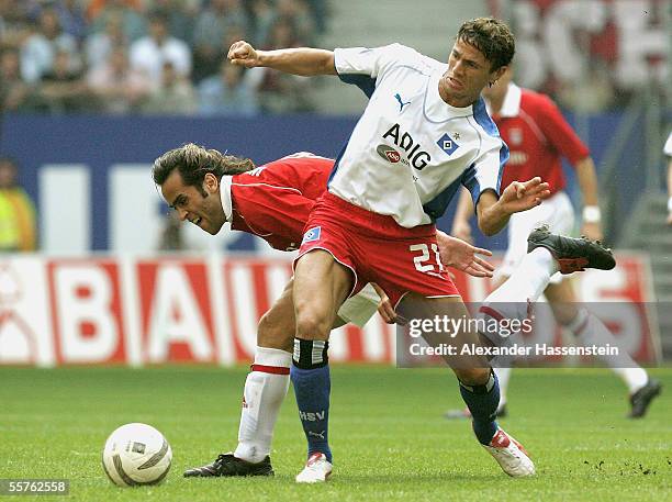 Khalid Boulahrouz of Hamburg challenges for the ball with Ali Karimi of Munich during the Bundesliga match between Hamburger SV and Bayern Munich at...