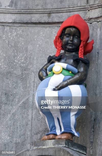 The famous Belgium's Maneken Pis sculpture is dressed as Obelix, a character of the Asterix cartoon, on the occasion of the 175th anniversary of...