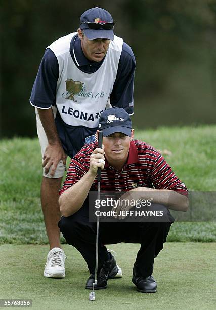 United States: Justin Leonard of the USA, lines up a putt with his caddie Brent Everson, during alternate ball Foursome match play against the...