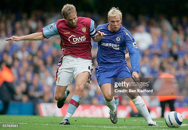 Olof Mellberg of Aston Villa battles with Eidur Gudjohnsen of Chelsea during the Barclays Premiership match between Chelsea and Aston Villa at...