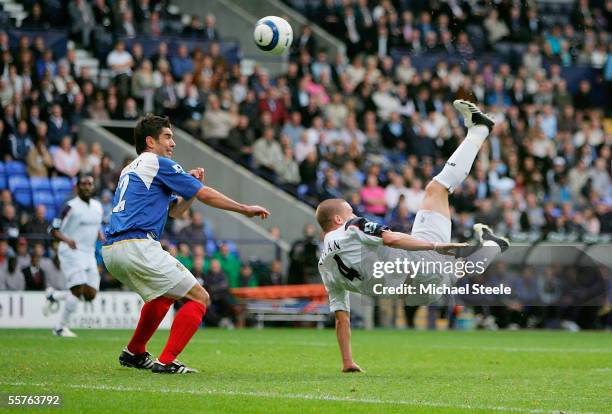 Kevin Nolan of Bolton scores with an overhead kick as Dejan Stefanovic of Portsmouth looks on during the Barclays Premiership match between Bolton...