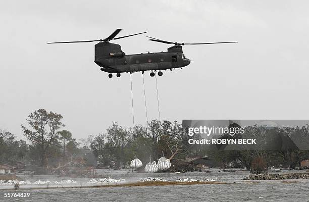 New Orleans, UNITED STATES: Helicopters drop sandbags on the breach of the Industrial Canal in the Ninth Ward of New Orleans 24 September 2005 after...