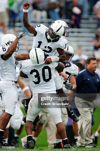 Fullback BranDon Snow lifts up quarterback Michael Robinson of the Penn State Nittany Lions after coming from behind to defeat the Northwestern...