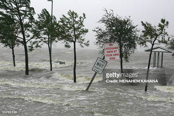 Lake Charles, UNITED STATES: Waves engulf a sign warning against swimming in Lake Charles, Louisiana, 24 September 2005, after hurricane Rita gave...