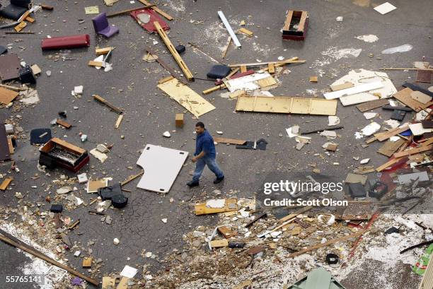 Man walks through a parking lot riddled with debris at Harrah?s Casino following Hurricane Rita September 24, 2005 in Lake Charles, Louisiana. Rita...