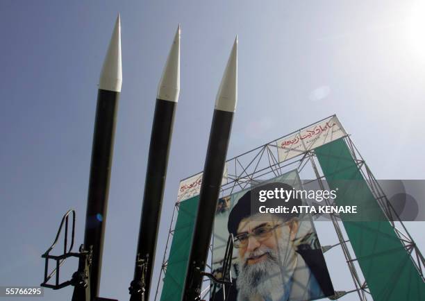 Russian-made Sam-6 surface-to-air missiles are seen in front of a portrait of Iran's Supreme Leader Ayatollah Ali Khamenei at a war exhibition to...