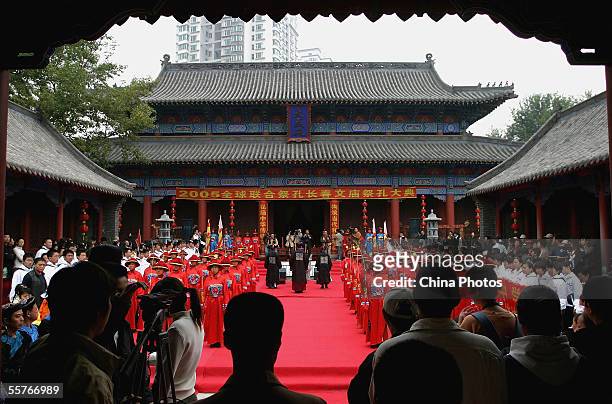 Confucian scholars and students dressed in ancient clothes pay respects to Confucius , during a ceremony to worship the Chinese philosopher and...