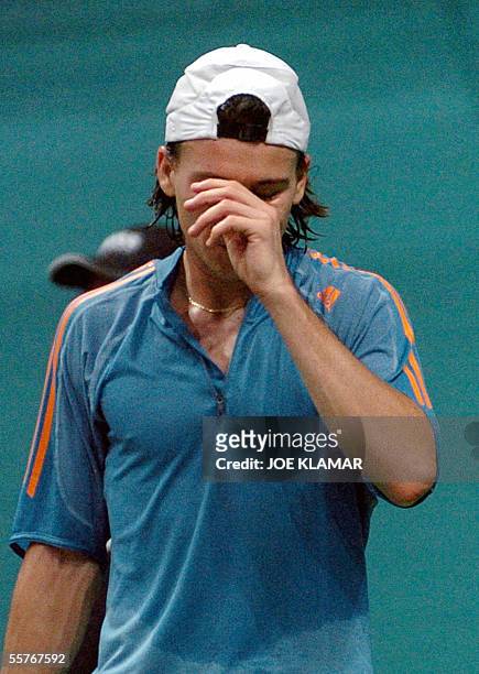 Argentina's Guillermo Coria raises his arm in reaction to his play against Slovakia's Dominik Hrbaty during the third day of World group semifinal...