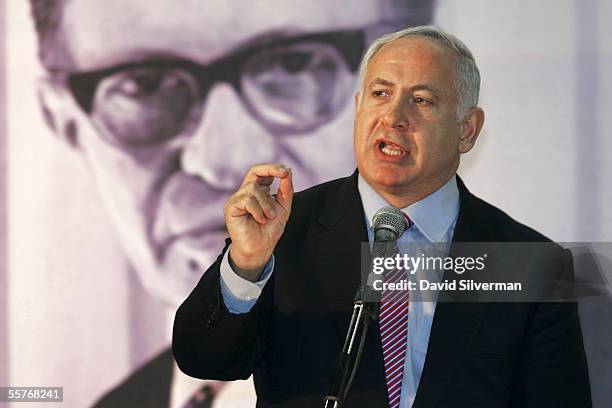 Former Israeli Prime Minister Benjamin Netanyahu makes his speech in front of a poster of the late Prime Minister Menahem Begin during a meeting of...