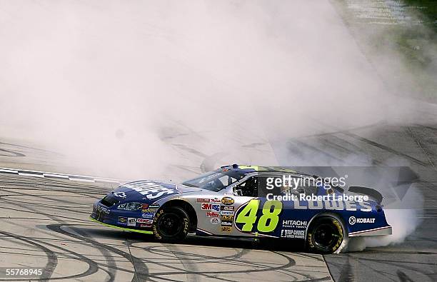 Jimmie Johnson, driver of the Hendrick Motorsports Lowe's Chevrolet, celebrates by burning out after winning the NASCAR Nextel Cup Series MBNA...