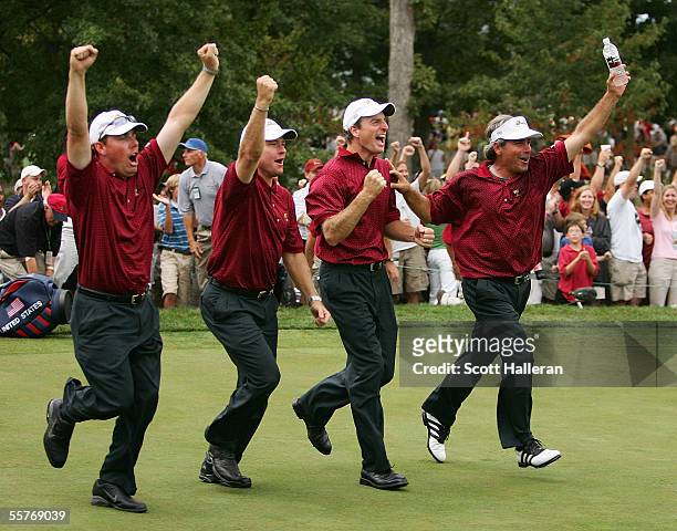 Members of the USA team, Justin Leonard, Scott Verplank; Jim Furyk and Fred Couples celebrate after Chris DiMarco made birdie on the 18th hole gave...