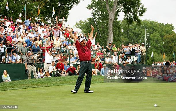 Team member Fred Couples reacts to making a putt on the 18th hole to win his match against International team member Vijay Singh 1 up during the...