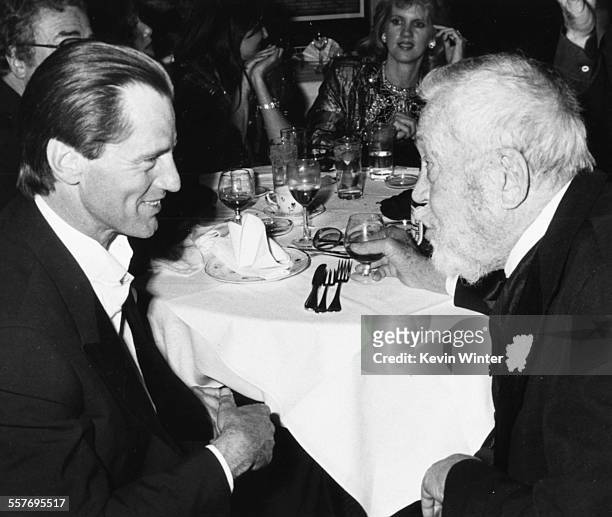 Playwright Sam Shepard talking to film director John Huston at their table, at Swifty Lazar's post-Oscar party at Spago's, Los Angeles, March 25th...