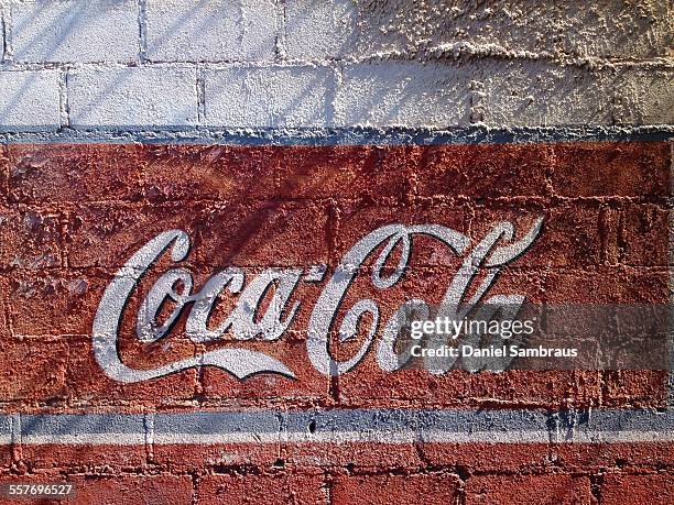 Fading Coca-Cola logo on a wall