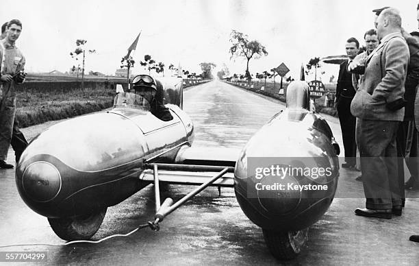 Italian racing driver Piero Taruffi driving his 'Double Torpedo' car, designer by Maserati, as part of a world record attempt, Terracina, Italy,...