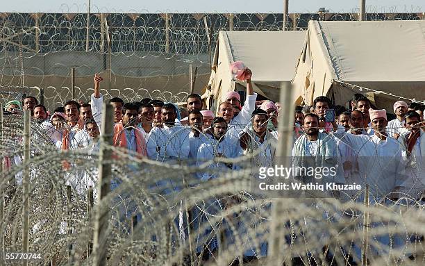 Iraqi Detainees stand in line to be processed for release from Abu Ghraib prison facility on September 26, 2005 in Abu Ghraib, 21 miles west of...