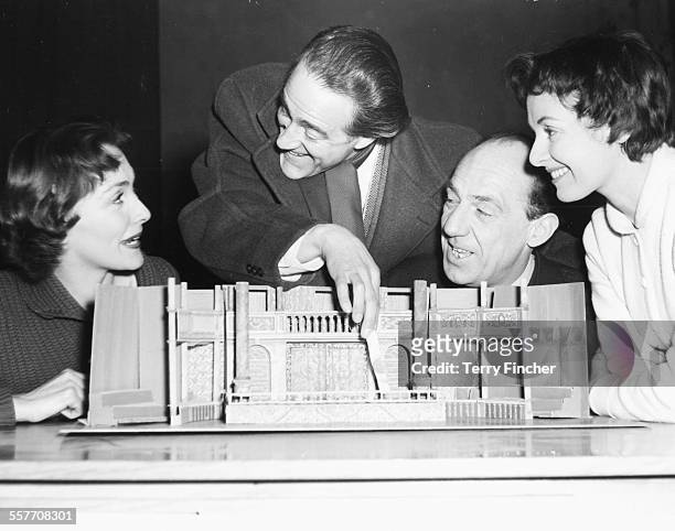 Actors Rachel Gurney, Hal Burton, Michael Hordern and Jane Wenham inspecting a model of the set for their next play, circa 1955.