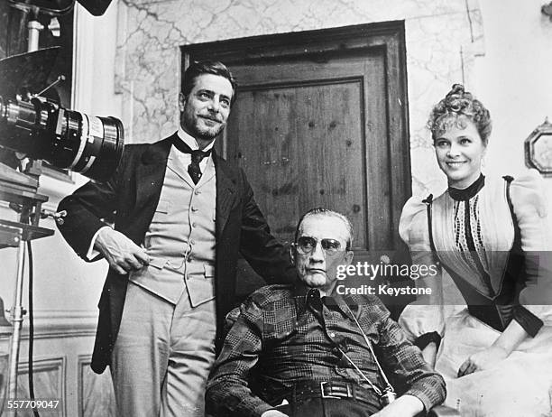 Director Luchino Visconti with actors Giancarlo Giannini and Laura Antonelli on the set of the film 'The Innocent' in Rome, January 1976.