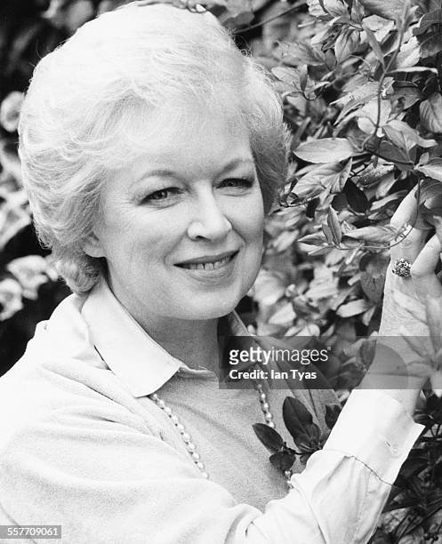 Portrait of actress June Whitfield in the garden of her home in Wimbledon, England, circa 1975.