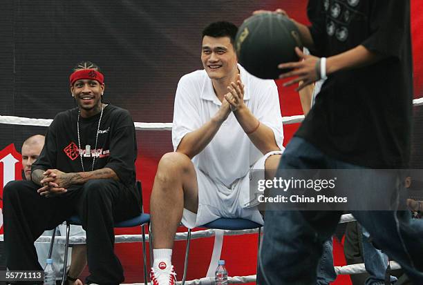 Star Allen Iverson of USA and Yao Ming of China watch fans play basketball during an event at Shanghai Stadium on September 25, 2005 in Shanghai,...